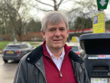 Cllr David Lewis at the Steels Lane car park in Oxshott - where half hour parking has been withdrawn